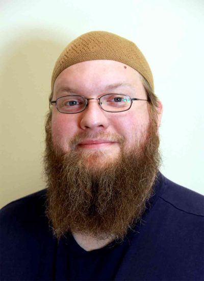 Duston Barto, an advocate for religious liberty and civil rights, pictured here with long beard and brown kufi cap.