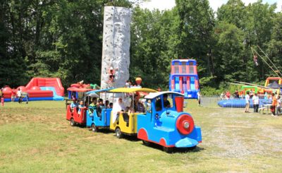 A colorful train carries kids of all ages through a carnival playground at ISGC that was created for celebrating a united Eid festival.