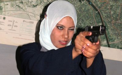 A Muslim woman takes sturdy aim of a handgun indoors. Take advantage of any self-defense classes for women offered in your area. Usually men are not allowed to be present during the classes, so inshaa'Allah you will feel comfortable & able to focus on your instructor & getting the techniques correct.