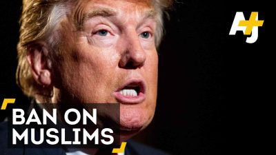 Imam Zaid speaks and sits in the sunlight indoors.