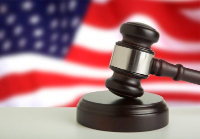 Religious liberty upheld. Concept photo shows a judge's gavel in front of a blurred American flag.